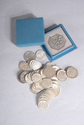 a small blue box with some silver coins in it