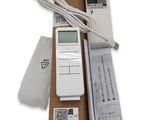 a white electronic device sitting on top of a cardboard box