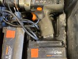 a box with a drill and other tools inside of it