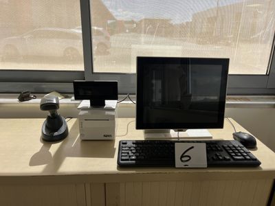 a desk with a computer, keyboard, mouse and monitor on it