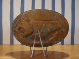 a large metal bowl on a stand on a wooden table