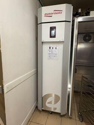 a white refrigerator in a kitchen next to a stainless steel counter