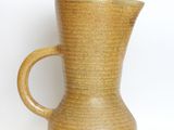 a brown vase with a handle on a white background