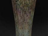 a vase that is sitting on a black surface