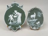 two green and white plates with a picture of a woman and a deer