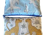 two pillows with cheetah and seagulls on them on a white background