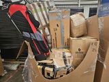 a pile of luggage sitting on top of cardboard boxes