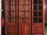 a large wooden cabinet with glass doors in a room