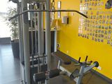 a gym room with a yellow wall and a black floor