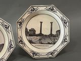 two black and white plates with a picture of a factory in the background