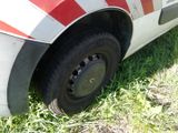 a red and white striped car parked in the grass