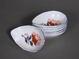 three white bowls with red and blue designs on them sitting on a table