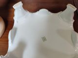 a white bowl sitting on a table next to a pair of shoes