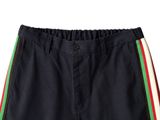 a close up of a black shorts with multi colored stripes