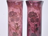 two vases sitting side by side on a white surface