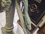 a statue of a dragon on a pedestal in a room