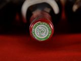 a close up of a bottle of wine on a red cloth