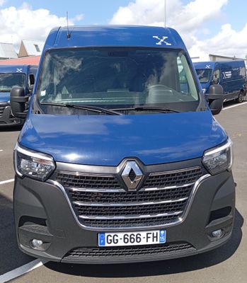 a blue van that is parked in a parking lot