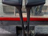 two black levers on the front of a red truck