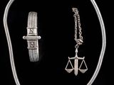 a silver necklace and bracelet set with a lady ' s scale and a lady ' s scale