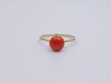 a gold ring with a red stone in the middle