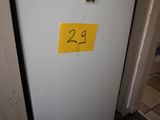 a white refrigerator with a yellow sticker on it