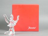 crystal figurine of a woman with a bow in front of a red box