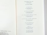 someone is holding a book open to a page with a list on it