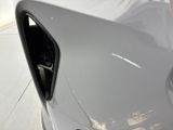 a close up of a car ' s door handle with a hole in it