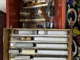 a box full of pens and pencils sitting on a table