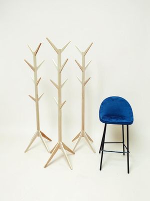 une chaise bleue et un porte-manteau en bois sur fond blanc