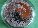 a silver coin with a picture of a bird on it