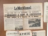 several old newspapers are displayed on a wall in a room