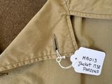 a label on the back of a jacket with a name tag