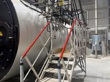 stairs leading up to a large boiler in a building