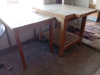 a wooden table with a wooden shelf underneath it in a room