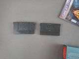 two nintendo game cartridges sitting next to each other on a table