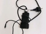 a black cord that is connected to a charger on a white surface