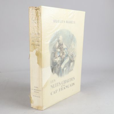 an old book sitting on top of a table next to a white wall