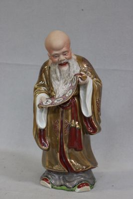 a figurine of a man with a white beard and a red robe