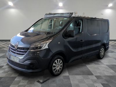 La camionnette noire est garée sur un sol en damier dans un garage.