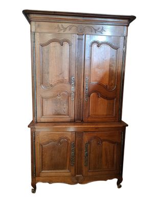 a wooden cabinet with two doors and a drawer underneath it