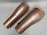 pair of brown leather boots with brown leather linings on a gray surface