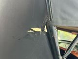 a close up of a black umbrella on top of a green vehicle