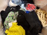 a pile of clothes that is sitting on the floor