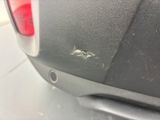 a close up of the rear end of a car with scratches on it
