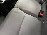 a seat belt in the back of a car with a cup holder attached to it
