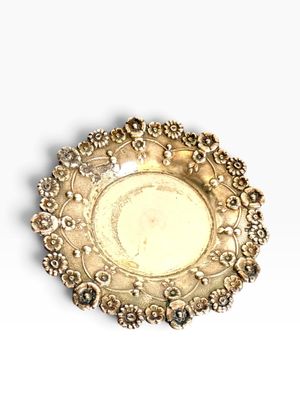 a silver plate on a white surface with a white background