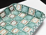 a blue and white tray that has a pattern on it