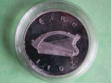 a close up of a coin in a plastic container on a green surface
